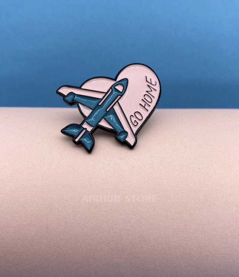 Pin with an airplane Go Home