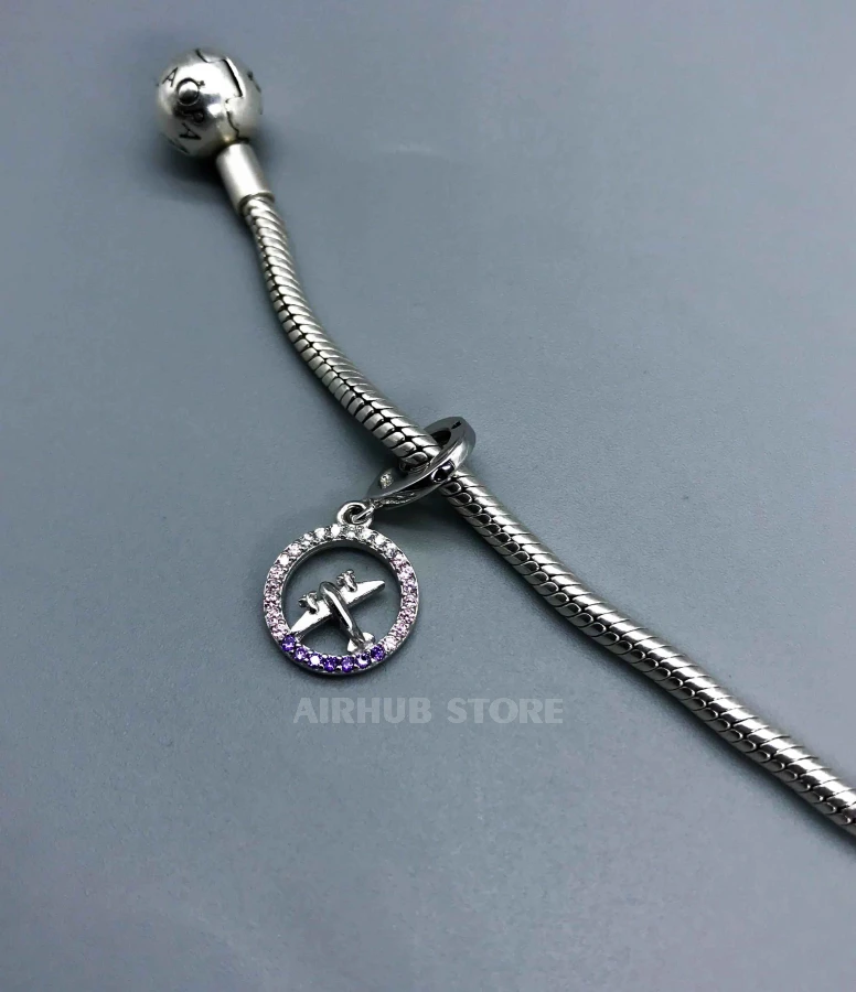Airplane charm with pink gemstones