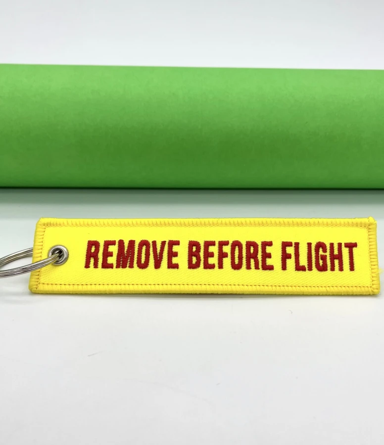 Remove Before Flight light yellow and red Keychain