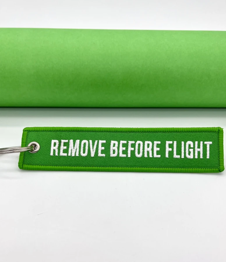 Remove Before Flight green Keychain