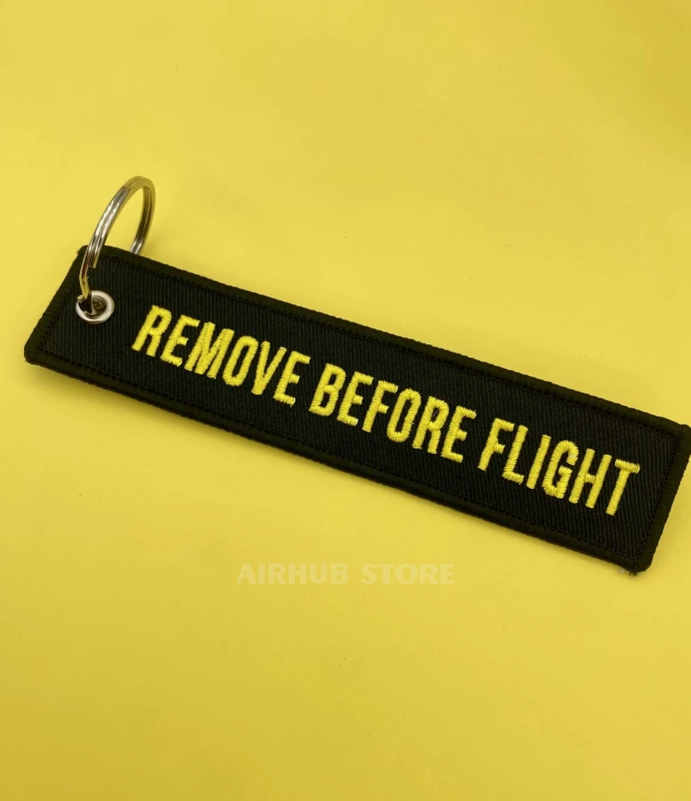 Remove Before Flight black and yellow Keychain